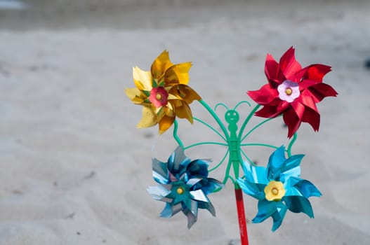 Shot of pinwheel toy on the sandy background