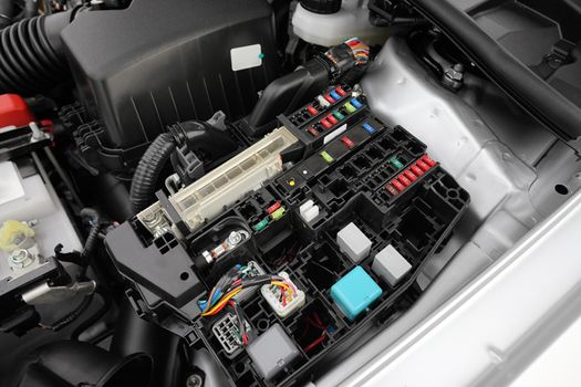 Detail of a car engine bay with fuses