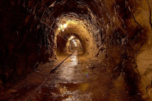 Mining tunnel with lights and rails