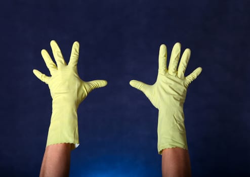 Hands in Rubber Gloves on the dark background
