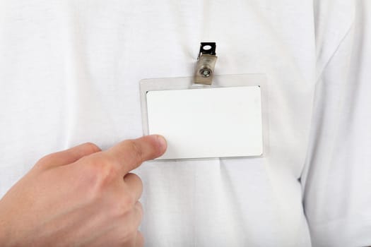 Person shows blank Badge on t-shirt closeup