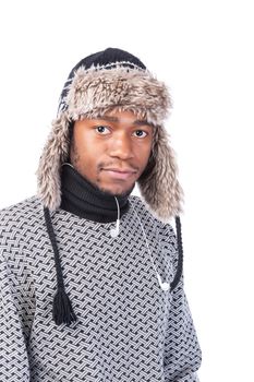 Young African-American wearing winter clothing but feeling cold in a white background