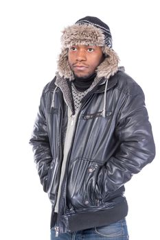 Young African-American wearing winter clothing but feeling cold in a white background