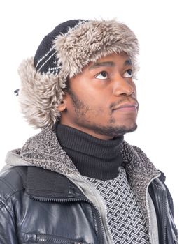 Portrait of a handsome smiling African-American wearing a fur hat and a winter jacket