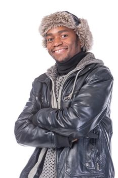 Young African-American wearing winter clothing but feeling cold in a white background