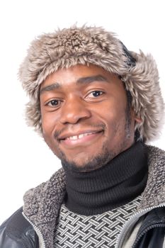 Portrait of a handsome smiling African-American wearing a fur hat and a winter jacket