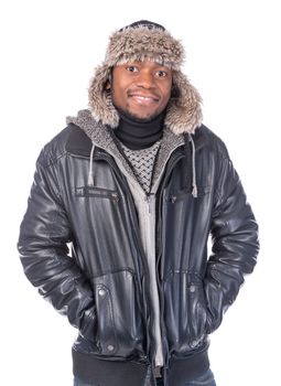 Young African-American wearing winter clothing but feeling cold in a white background