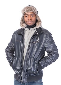 Young African-American wearing winter clothing but feeling cold in a white background