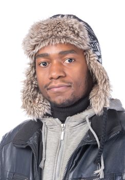 Portrait of a handsome smiling African-American wearing a fur hat and a winter jacket
