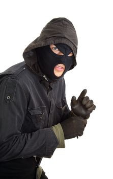 Robber in a black mask sneaking inside