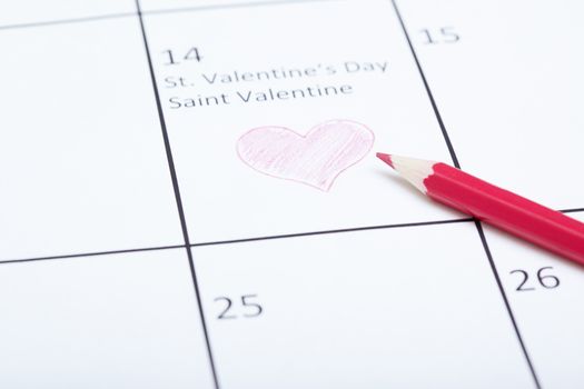 Red pencil on a calendar with Saint Valentine Day