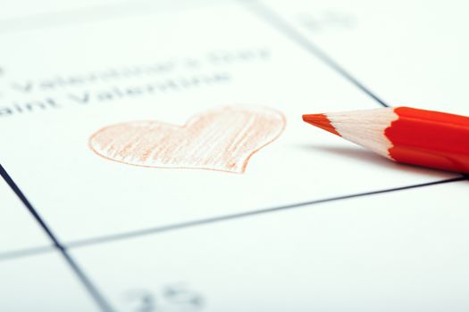 Red pencil on a calendar with Saint Valentine Day