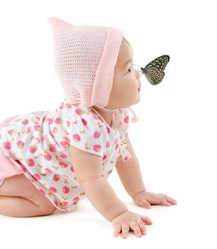 Butterfly flying to Asian baby girl nose, isolated on white background
