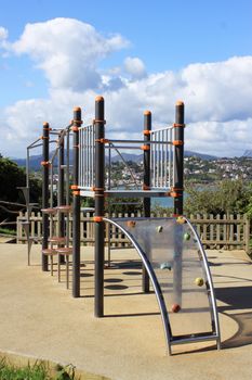 a playground in an amusement park near the sea over a mountain