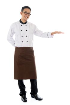 Full body Asian male chef hand showing blank space, standing isolated white background.