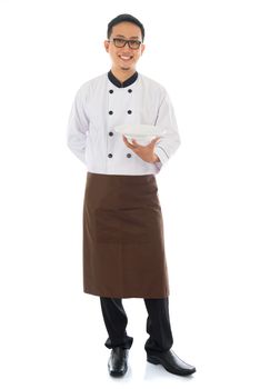 Full body Asian chef holding an empty plate, standing isolated on white background.