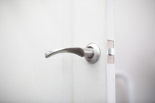 Close-up view on the wooden door with metal handle