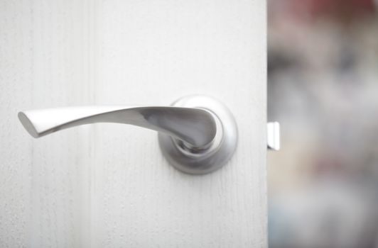 Close-up view on the wooden door with metal handle