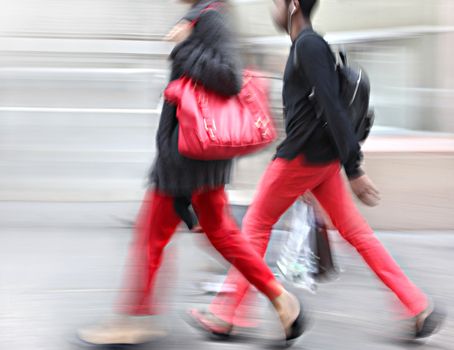 Young people at rush hour walking in the street. Intentional  motion blur