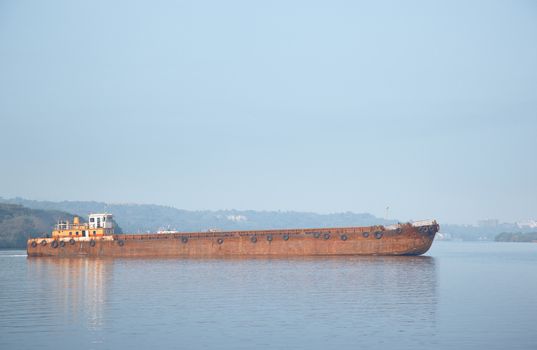 Old cargo vessel in the sea. Horizontal photo