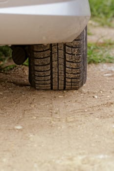 close up about car wheels on a dusty road