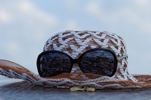 hat with sunglasses under the sky