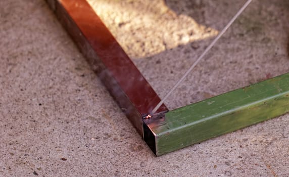 Iron welding with bright light and smoke at manufacturing