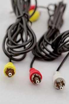 three audio (left - right) - video RCA cable and plug (red, white, yellow) on white background