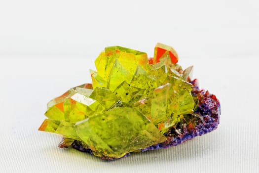 Close up picture about a crystal with topaz color on white background (yellow crystal)