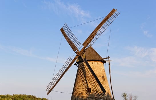 Old wooden windmill against the blue sky