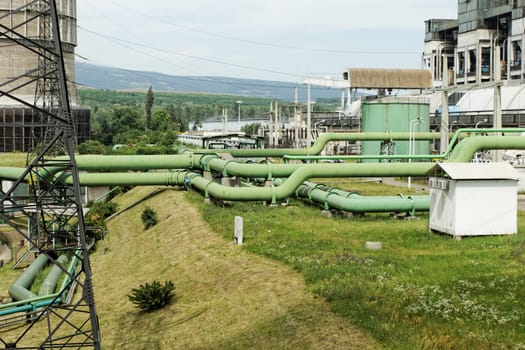 green industrial pipes of a power plant