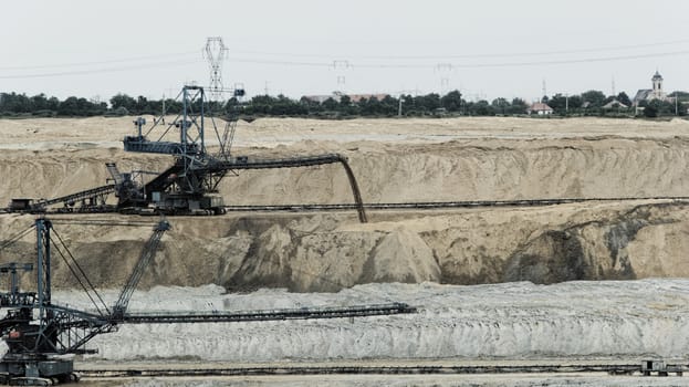 Coal mining in an open pit with huge industrial machine