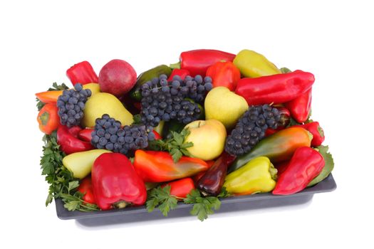 Ripe pears , apples , grapes and pepper on a platter. Presented on a white background.