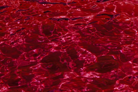 red abstract background of wavy water surface