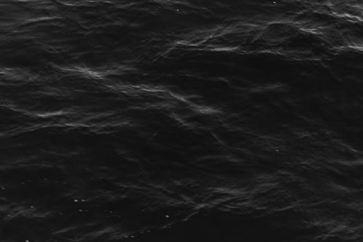 grey abstract background of wavy water surface