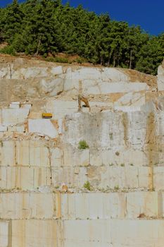 Detail of huge Thassos white marble quarry (mine) with grabber