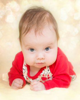 4 months old baby girl on a glitter bokeh background