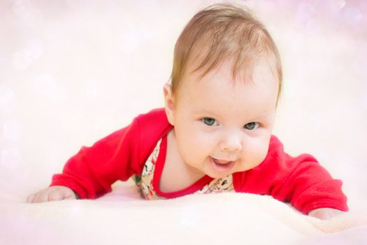 4 months baby girl on a glitter bokeh background