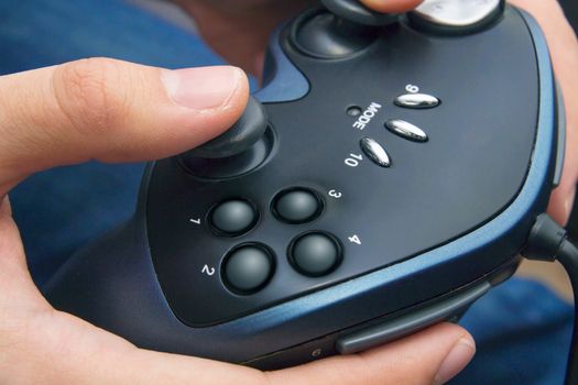 Closeup of male hands with gamepad game controller
