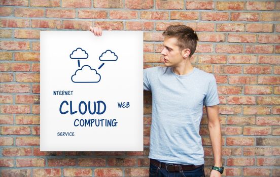 Young man holding whiteboard with cloud computing content