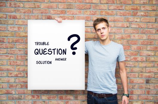 Young man holding whiteboard with question and solution words