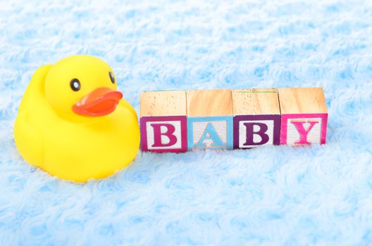 Baby blocks spelling baby and a rubber duck