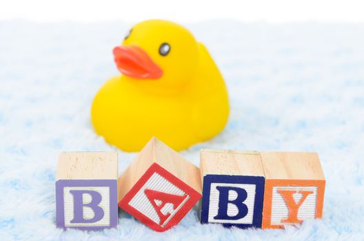Baby blocks spelling baby and a rubber duck