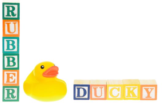 Baby blocks spelling rubber ducky with a rubber duck. Isolated on a white background