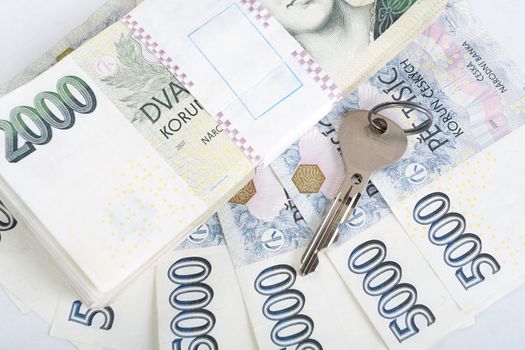 czech banknotes nominal value one and two thousand crowns and key as money concept key to Success