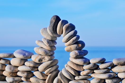 Arch stones between of the pebbles on the coast