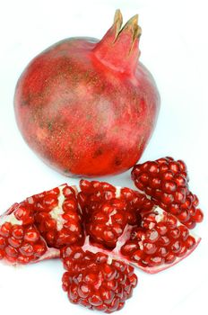 Big Ripe Pomegranate Full Body and Slices isolated on white background