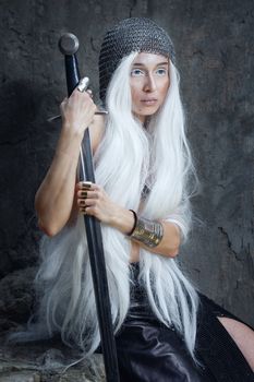 Girl with long white hair in chain mail and sword