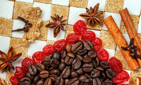 Sweets, spices and coffee beans laid out on a background of refined sugar