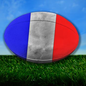 Rugby ball with France flag over grass